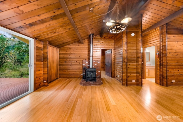 44111 SE Mt Si Rd, North Bend, WA 98045 - unfurnished living room with wood ceiling, a wood stove, light wood-style flooring, a chandelier, and wooden walls