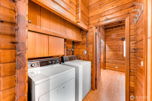 44111 SE Mt Si Rd, North Bend, WA 98045 - washroom featuring washer and clothes dryer, light wood-style floors, and wooden walls