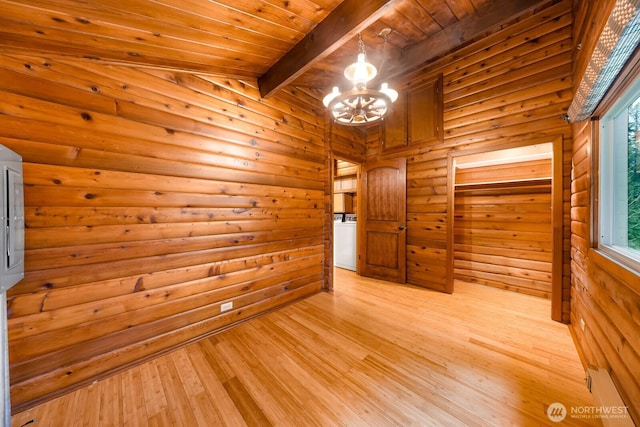 44111 SE Mt Si Rd, North Bend, WA 98045 - spare room with a chandelier, a wood ceiling with exposed beams, washer / dryer, light wood-style flooring, and wood walls