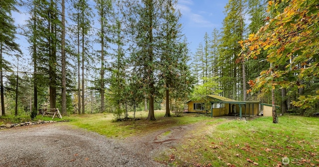 44111 SE Mt Si Rd, North Bend, WA 98045 - view of yard featuring driveway, a carport, and a wooded view