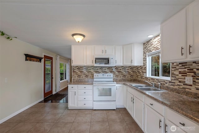 31108 3rd Ave Unit 330, Black Diamond, WA 98010 - kitchen featuring white appliances, tasteful backsplash, light tile patterned floors, and white cabinets