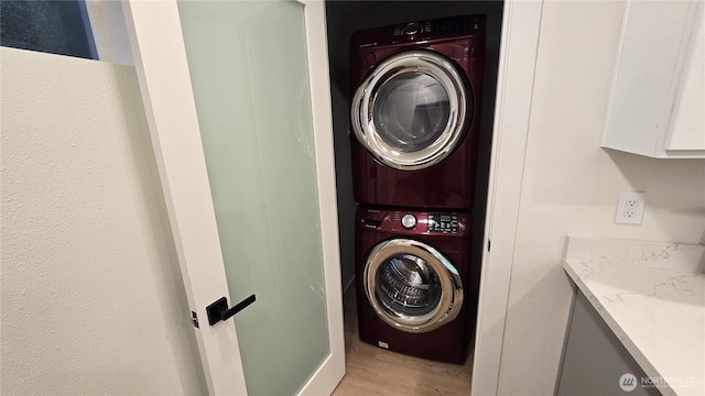 744 N 88th St, Seattle, WA 98103 - washroom with stacked washer and clothes dryer and light wood finished floors