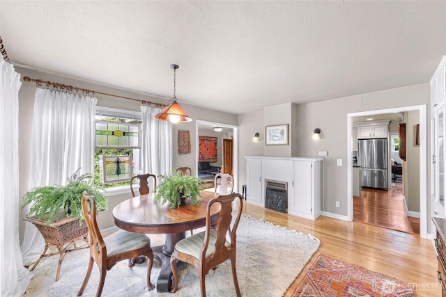 105 Shuksan St, Everson, WA 98247 - dining space featuring a textured ceiling, light wood finished floors, and a fireplace
