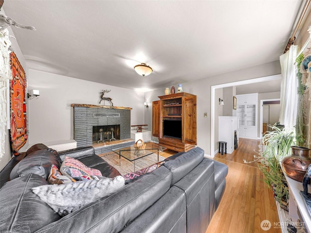 105 Shuksan St, Everson, WA 98247 - living area with wood finished floors and a fireplace with raised hearth