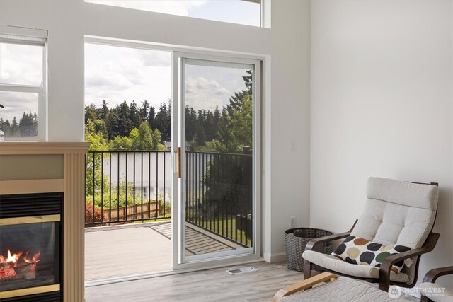 2311 Milton Way Unit E, Milton, WA 98354 - entryway featuring a glass covered fireplace and wood finished floors