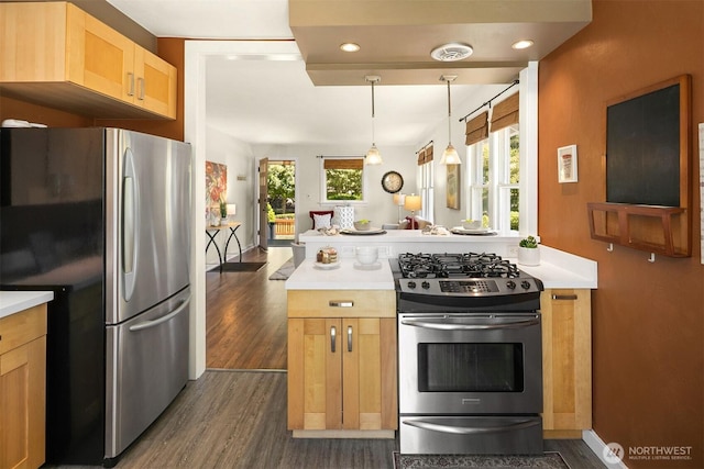 4521 47th Ave SW, Seattle, WA 98116 - kitchen with appliances with stainless steel finishes, dark wood-style floors, light countertops, pendant lighting, and open floor plan
