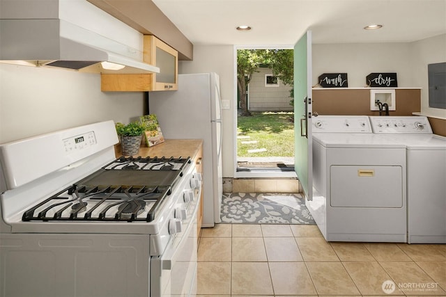 4521 47th Ave SW, Seattle, WA 98116 - kitchen featuring gas range gas stove, premium range hood, washer and clothes dryer, light countertops, and recessed lighting