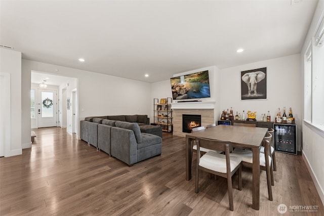 14717 73rd St E, Sumner, WA 98390 - living room with a warm lit fireplace, wood finished floors, beverage cooler, a dry bar, and recessed lighting