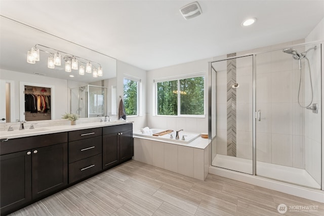 14717 73rd St E, Sumner, WA 98390 - full bath featuring a stall shower, a bath, double vanity, and a walk in closet