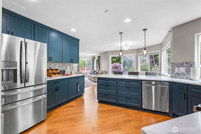 1818 Fisher Ave, Dupont, WA 98327 - kitchen with appliances with stainless steel finishes, backsplash, light countertops, light wood finished floors, and recessed lighting