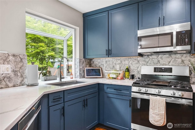 1818 Fisher Ave, Dupont, WA 98327 - kitchen featuring appliances with stainless steel finishes, blue cabinets, and tasteful backsplash