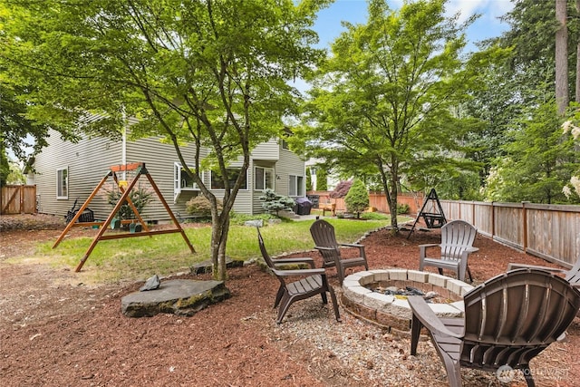 1818 Fisher Ave, Dupont, WA 98327 - fenced backyard featuring an outdoor fire pit and a playground