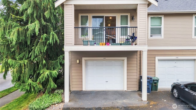 2104 Palisade Blvd Unit B-7, Dupont, WA 98327 - view of front facade with a garage, a balcony, and driveway