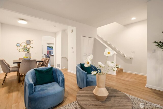 2840 139th Ave SE Unit 16, Bellevue, WA 98005 - living area with light wood-style flooring, arched walkways, recessed lighting, and stairs