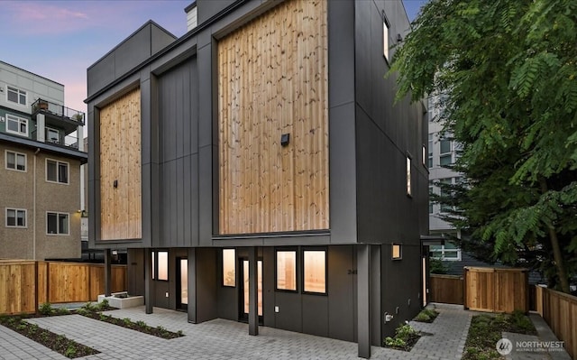 2419 NW 57th Unit B, Seattle, WA 98107 - back of house at dusk with a patio area