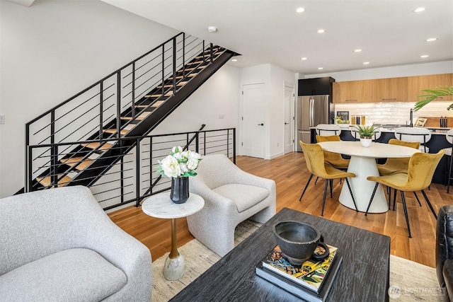 2419 NW 57th Unit B, Seattle, WA 98107 - living room featuring recessed lighting, light wood-type flooring, and stairway