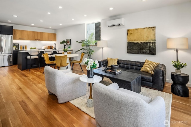 2419 NW 57th Unit B, Seattle, WA 98107 - living area featuring an AC wall unit, light wood-type flooring, and recessed lighting