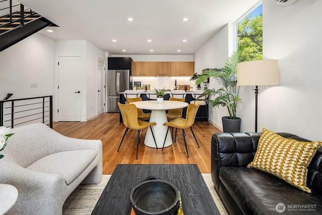 2419 NW 57th Unit B, Seattle, WA 98107 - living room featuring recessed lighting, light wood-style flooring, and a wall mounted air conditioner