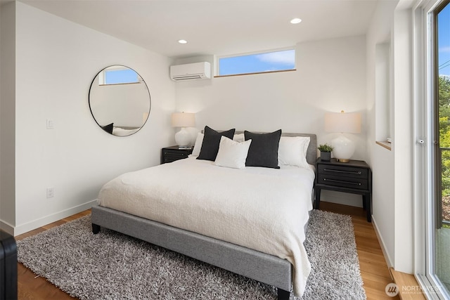 2419 NW 57th Unit B, Seattle, WA 98107 - bedroom with wood finished floors, an AC wall unit, and recessed lighting