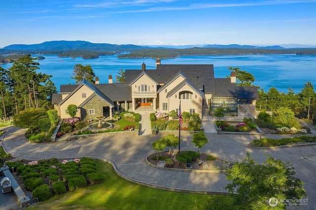 678 Primrose Ln, Friday Harbor, WA 98250 - view of front of property featuring a chimney, a balcony, and a water and mountain view