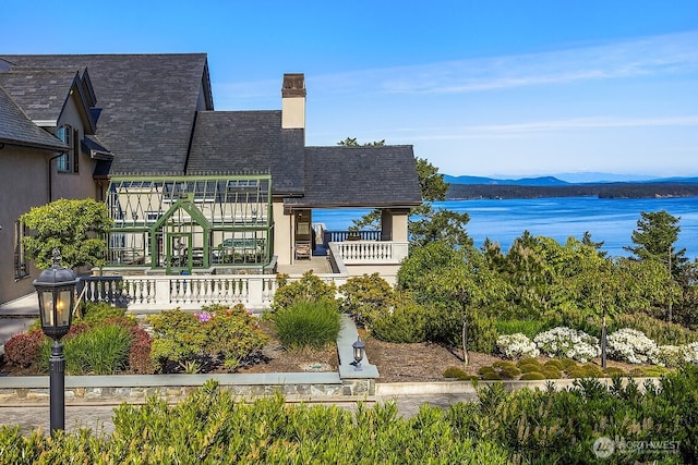 678 Primrose Ln, Friday Harbor, WA 98250 - rear view of property featuring a chimney and a water and mountain view