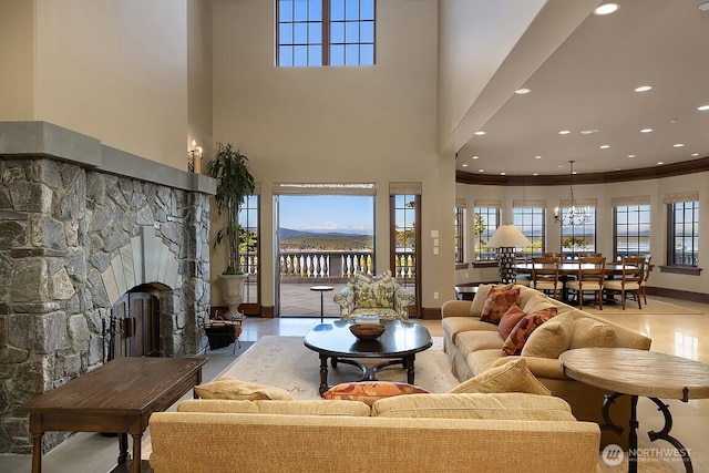 678 Primrose Ln, Friday Harbor, WA 98250 - living area with a high ceiling, a stone fireplace, recessed lighting, crown molding, and a chandelier