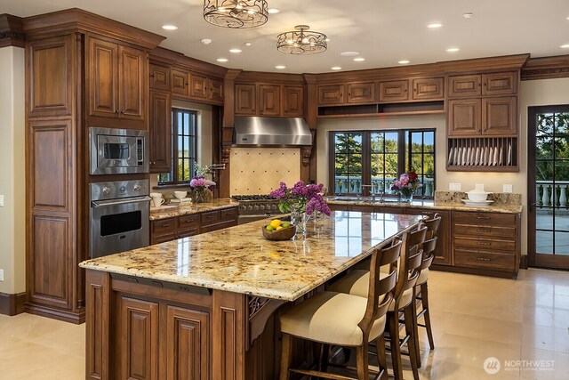 678 Primrose Ln, Friday Harbor, WA 98250 - kitchen with stainless steel appliances, ventilation hood, recessed lighting, light stone countertops, and backsplash