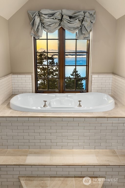 678 Primrose Ln, Friday Harbor, WA 98250 - bathroom featuring vaulted ceiling, healthy amount of natural light, and a garden tub