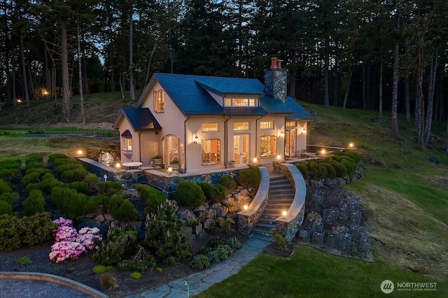 678 Primrose Ln, Friday Harbor, WA 98250 - view of front of home featuring a chimney, stucco siding, and stairway