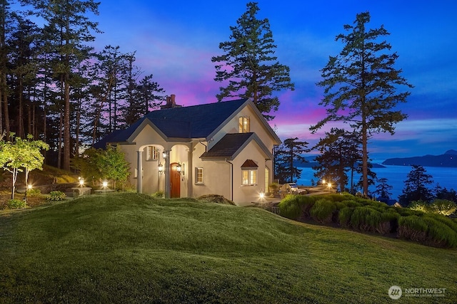 678 Primrose Ln, Friday Harbor, WA 98250 - view of front facade with stucco siding, a yard, and a chimney