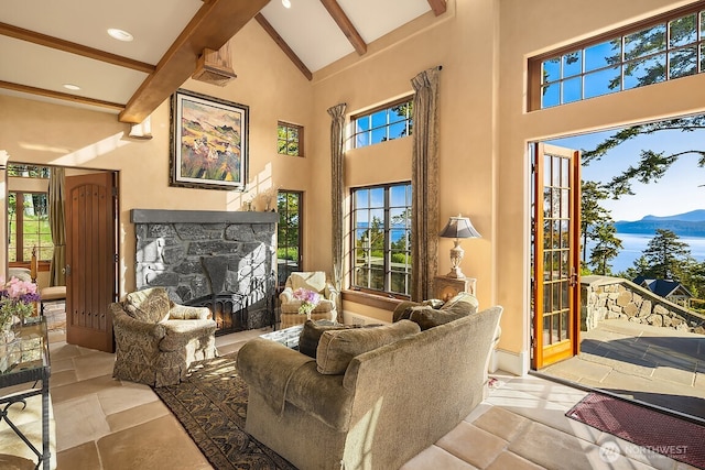 678 Primrose Ln, Friday Harbor, WA 98250 - living room featuring beamed ceiling, high vaulted ceiling, a fireplace, recessed lighting, and stone tile flooring