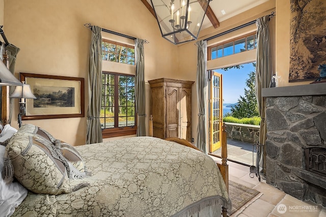 678 Primrose Ln, Friday Harbor, WA 98250 - bedroom with access to exterior, multiple windows, a chandelier, a high ceiling, and beamed ceiling