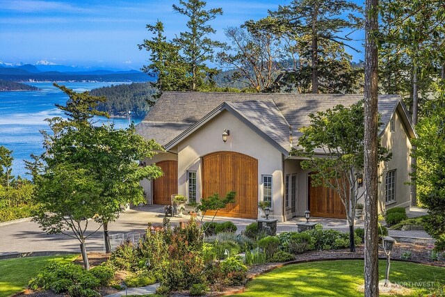 678 Primrose Ln, Friday Harbor, WA 98250 - view of front of house with stucco siding and a water view