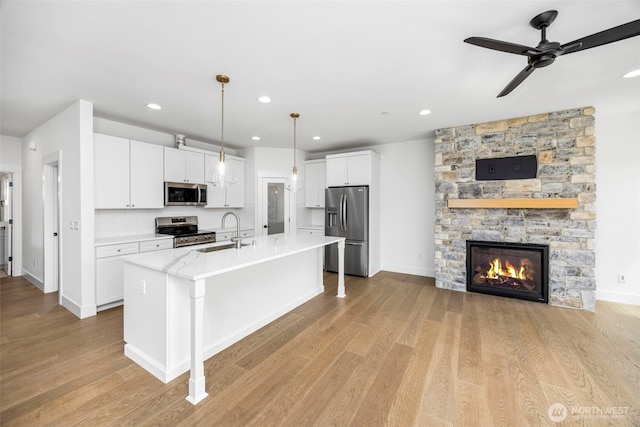 9 160th St SE, Bothell, WA 98012 - kitchen with appliances with stainless steel finishes, white cabinets, a ceiling fan, light wood finished floors, and recessed lighting