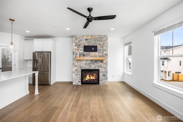 9 160th St SE, Bothell, WA 98012 - unfurnished living room with a ceiling fan, light wood-style flooring, a fireplace, and recessed lighting