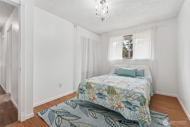15627 SE 263rd Pl, Covington, WA 98042 - bedroom with a textured ceiling and wood finished floors