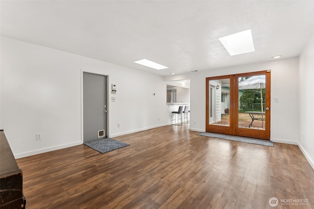 15627 SE 263rd Pl, Covington, WA 98042 - unfurnished living room with a skylight, wood finished floors, and recessed lighting