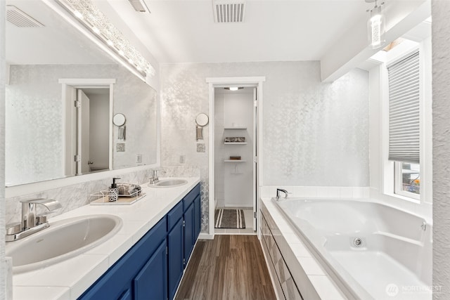 15627 SE 263rd Pl, Covington, WA 98042 - full bathroom featuring double vanity, a whirlpool tub, and wood finished floors