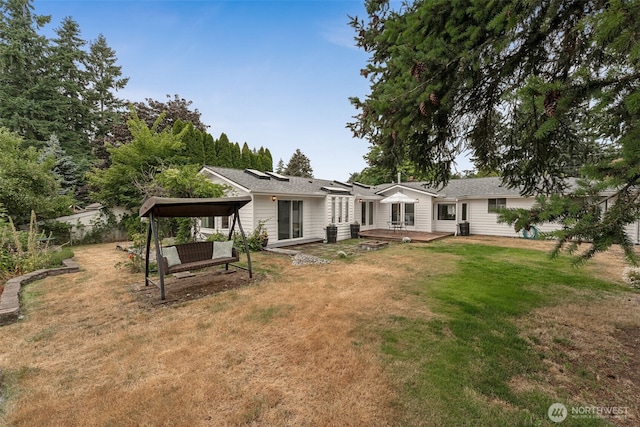 15627 SE 263rd Pl, Covington, WA 98042 - rear view of property featuring a lawn, a deck, a patio area, and a detached carport