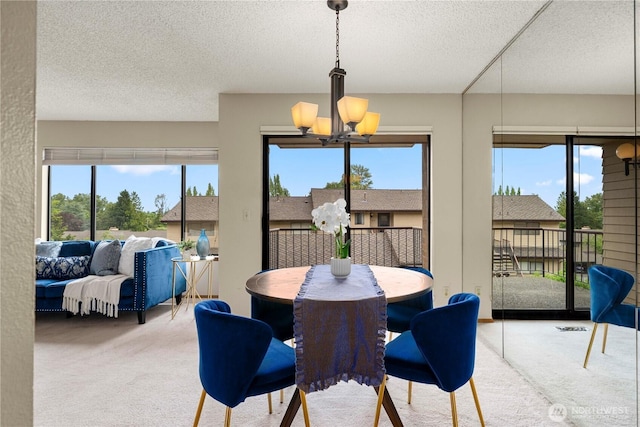 10637 Glen Acres Dr S Unit 10637, Seattle, WA 98168 - dining space featuring carpet floors, a chandelier, a textured ceiling, and healthy amount of natural light