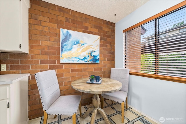 10637 Glen Acres Dr S Unit 10637, Seattle, WA 98168 - dining room with brick wall and a textured ceiling