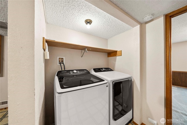 10637 Glen Acres Dr S Unit 10637, Seattle, WA 98168 - laundry room featuring a textured ceiling and washer and clothes dryer