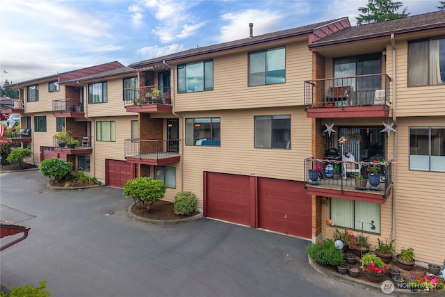 10637 Glen Acres Dr S Unit 10637, Seattle, WA 98168 - view of building exterior with an attached garage and driveway