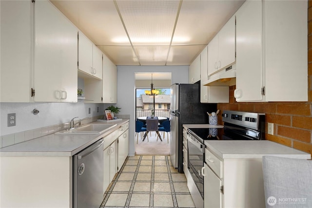 10637 Glen Acres Dr S Unit 10637, Seattle, WA 98168 - kitchen with appliances with stainless steel finishes, under cabinet range hood, white cabinetry, light countertops, and backsplash