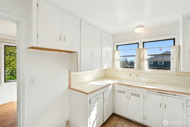 2000 31st Ave S, Seattle, WA 98144 - kitchen with backsplash, white cabinets, and tile counters