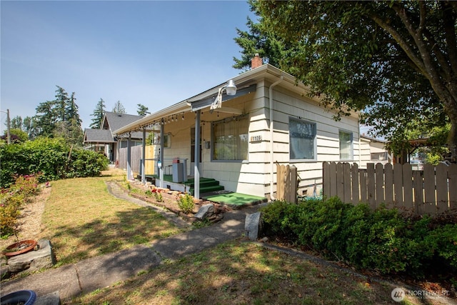 1109 S 61st St, Tacoma, WA 98408 - view of home's exterior with a chimney