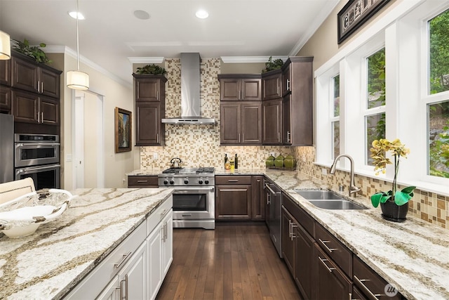 19501 58th Ave SE, Bothell, WA 98012 - kitchen with appliances with stainless steel finishes, wall chimney range hood, dark brown cabinetry, light stone countertops, and crown molding