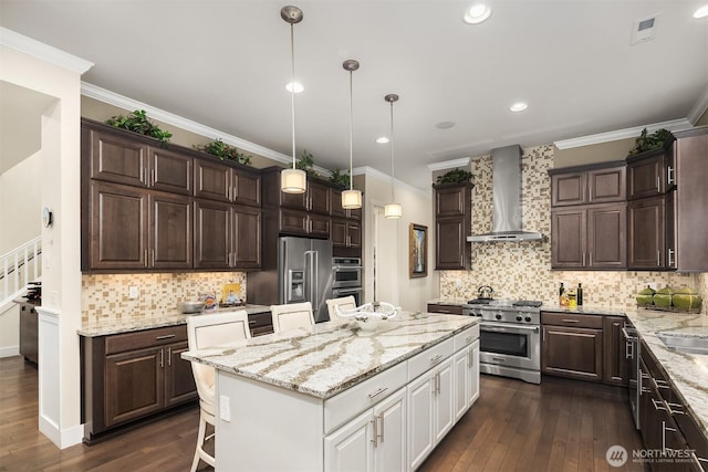 19501 58th Ave SE, Bothell, WA 98012 - kitchen with high end appliances, wall chimney exhaust hood, dark brown cabinets, crown molding, and recessed lighting