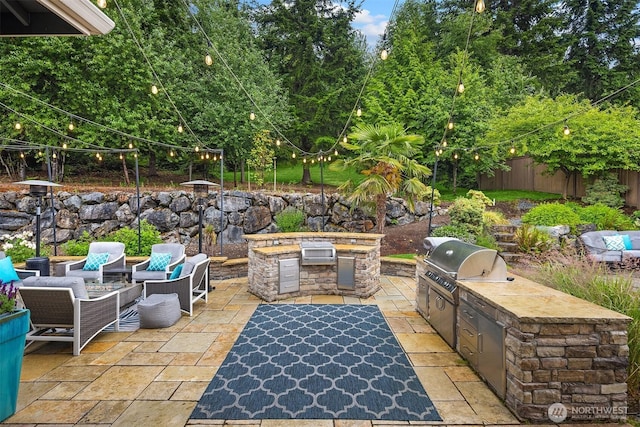 19501 58th Ave SE, Bothell, WA 98012 - view of patio featuring area for grilling, view of wooded area, and outdoor lounge area