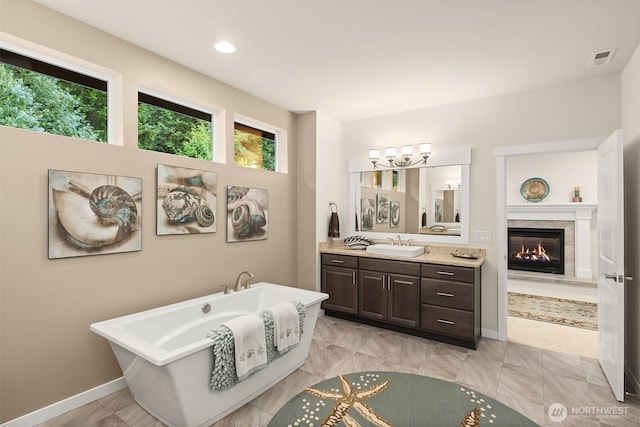 19501 58th Ave SE, Bothell, WA 98012 - bathroom with a soaking tub, vanity, a fireplace, and recessed lighting